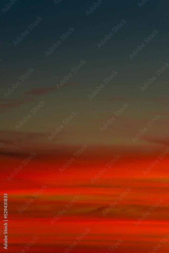 Cover page with gradient soft deep orange sky, illuminated clouds at bloody sunset as a background.