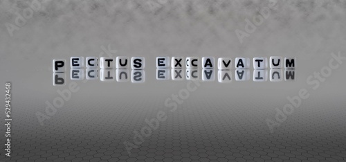 pectus excavatum word or concept represented by black and white letter cubes on a grey horizon background stretching to infinity