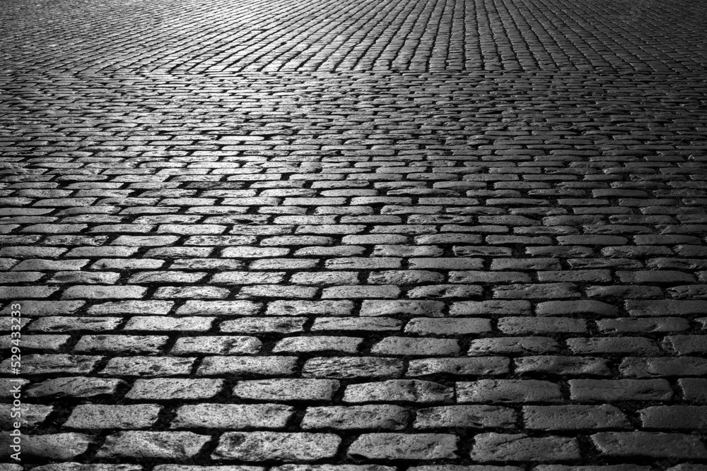Old cobblestones on Market place “Grote Markt“ in Antwerp Belgium. Shiny historic basalt ashlars and blocks reflecting sunshine. Pavement background, black and white greyscale with high contrast. Old cobblestones on Market place “Grote Markt“ in Antwerp Belgium. Shiny historic basalt ashlars and blocks reflecting sunshine. Pavement background, black and white greyscale with high contrast.