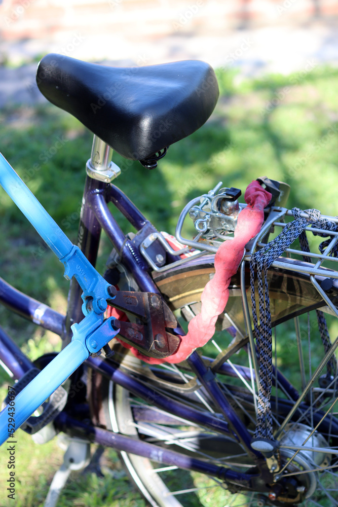 Close up photo of bicycle being stolen. Man Breaks a bike chain with pliers. Bicycle thief.  