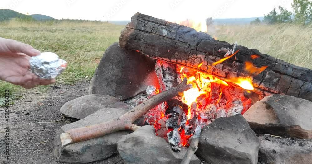 Girl is cooking potato and Ukrainian Salo (fat) on fire in wilderness Girl is cooking potato and Ukrainian Salo (fat) on fire in wilderness