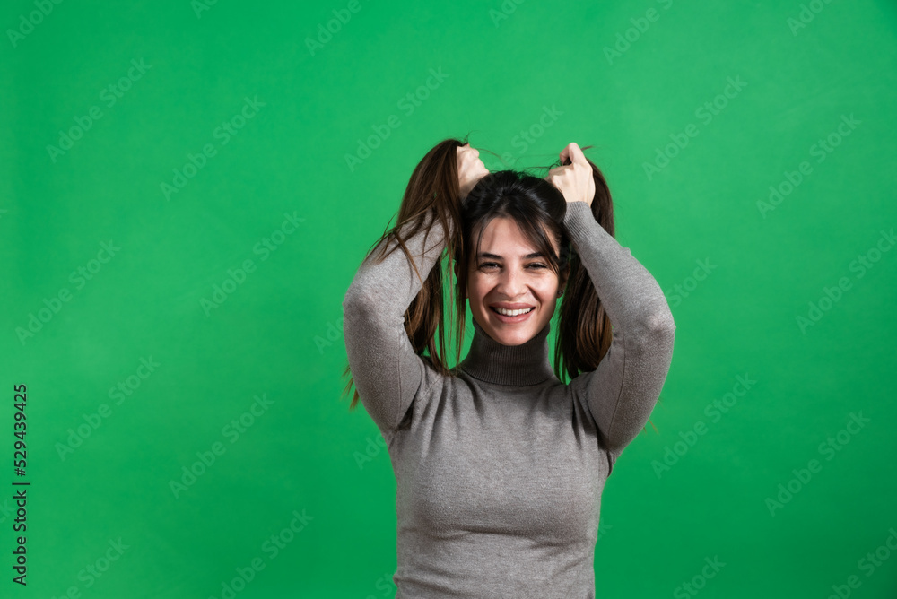 Young beautiful woman or girl model posing in front of green screen background. Portrait of a female with chroma key background. Young beautiful woman or girl model posing in front of green screen background. Portrait of a female with chroma key background.