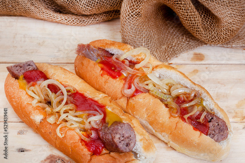 South African famous boerewors roll, juicy and topped with onions on a rustic surface photo