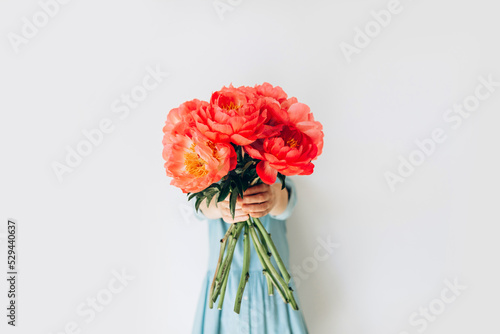 Woman with bouquet of beautiful peonies on white background, close up. Flowers to gift. Spring time and inspiration photo