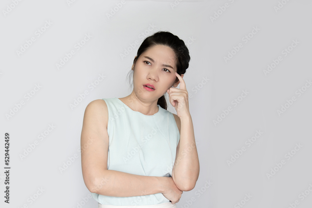 Asian beautiful woman use indicate finger touch temple with thoughtful and confusing and a question in mind Asian beautiful woman use indicate finger touch temple with thoughtful and confusing and a question in mind