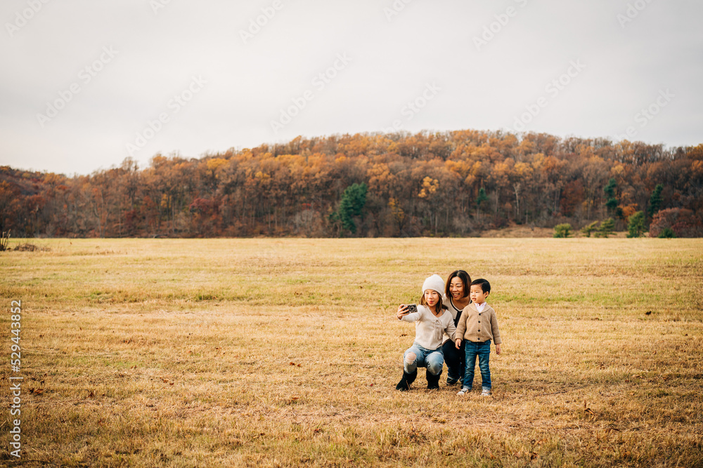 portrait of a family playing outside in autumn portrait of a family playing outside in autumn