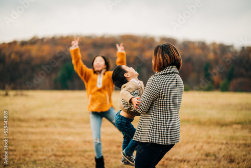 portrait of a family playing outside in autumn