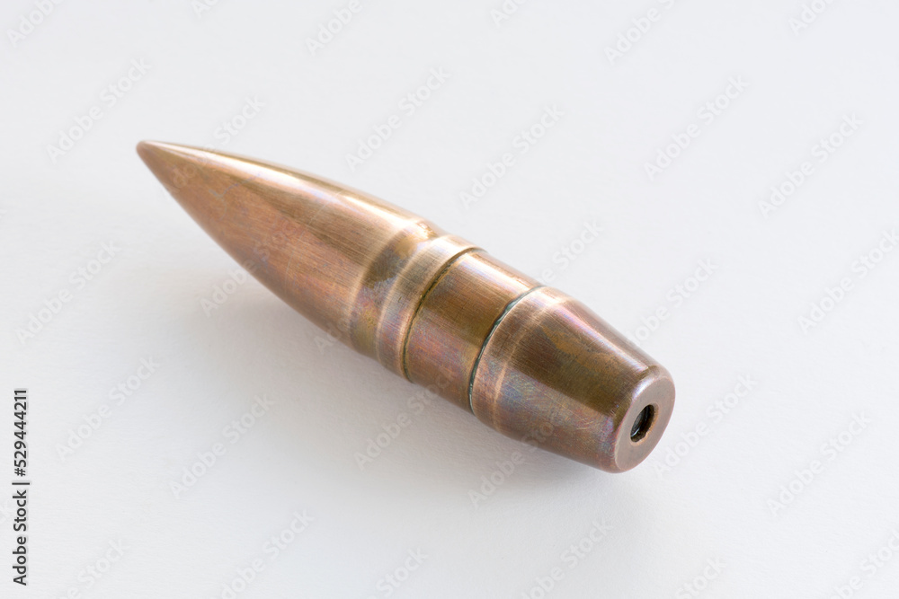 Obraz premium Armour piercing inert round projectile odrnance bullet for the French Hotchkiss 25 mm S.A. Mle 1934 anti-tank gun. Military theme. copper sheathed crimped in the brass cartridge case. Whate background