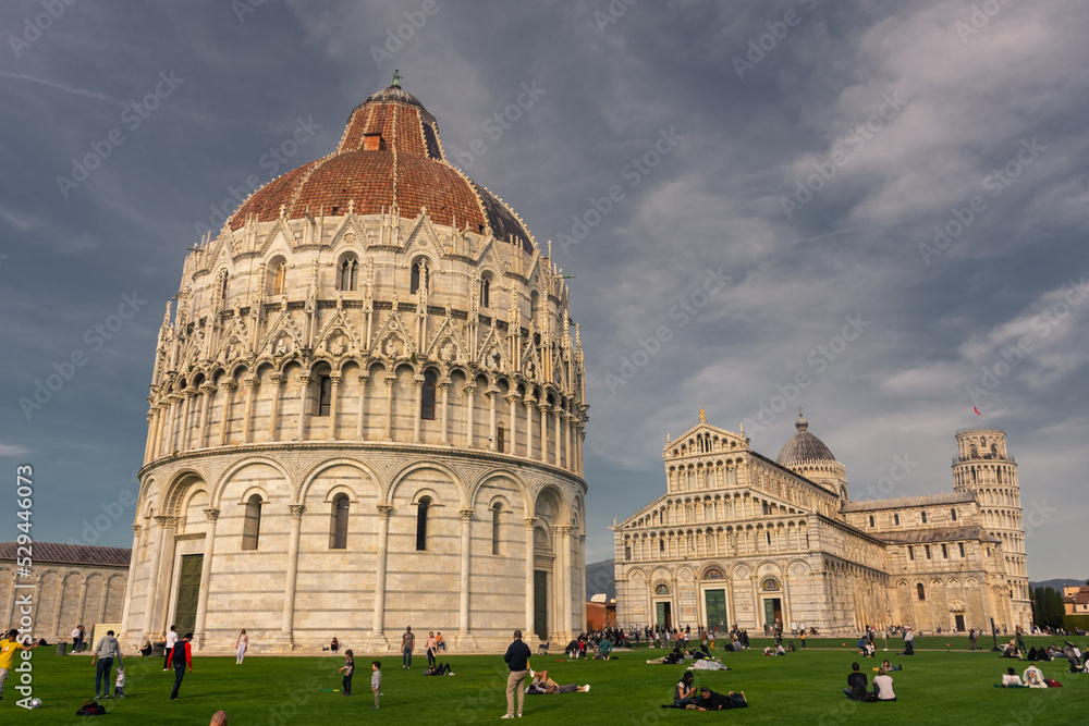 Pisa,  Italy, 14 April 2022: View of the Baptistery in cloudy sky