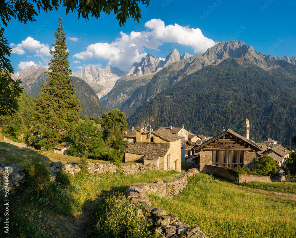 The Soglio village and Piz Badile, Pizzo Cengalo, and Sciora peaks in the Bregaglia range - Switzerland.