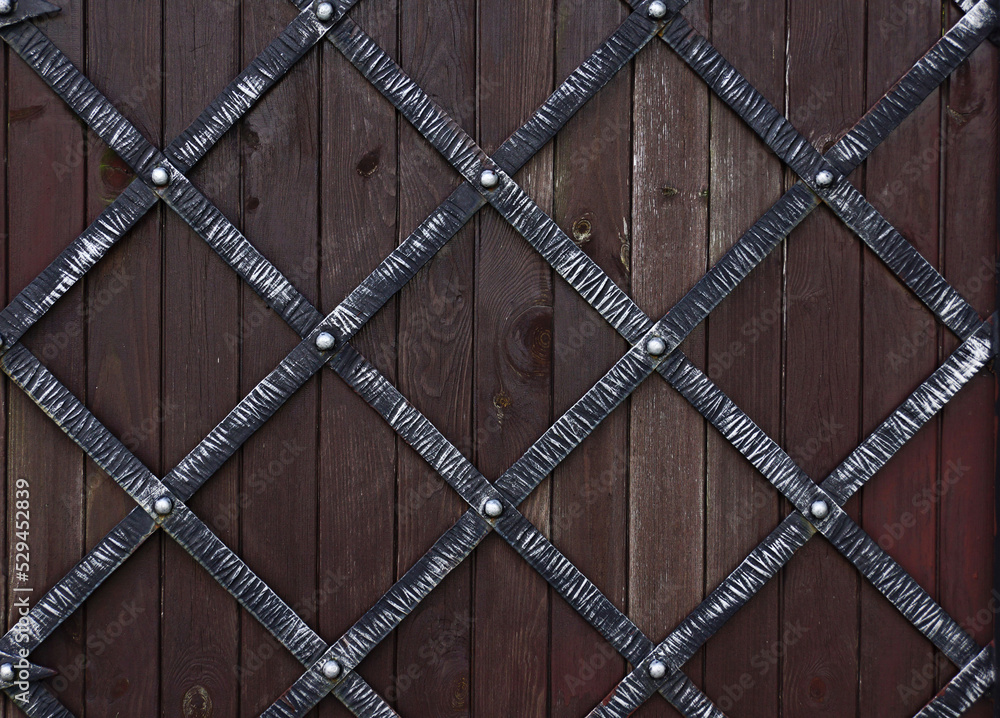 Wrought-iron gates with wooden backdrop
