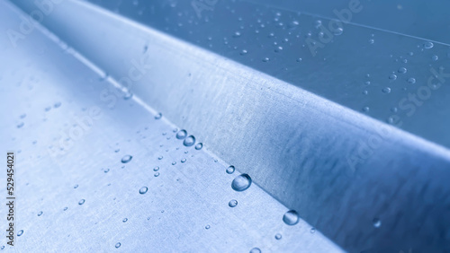 Raindrops on the metal sheet used in the background.