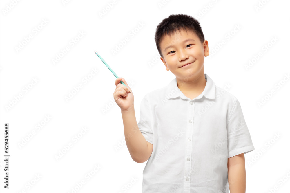 Smiling kid holding pencil and pointing to the left, wearing white shirt Smiling kid holding pencil and pointing to the left, wearing white shirt