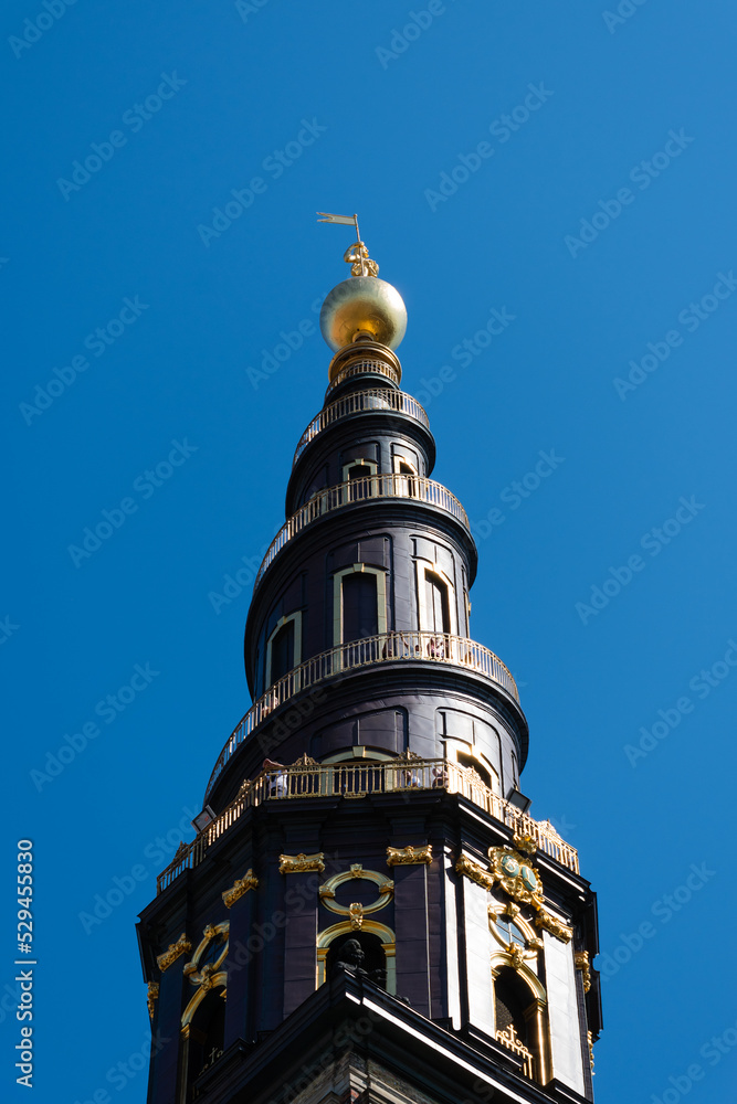 Spiral top of the tower of Church of Our Saviour in Copenhagen, Denmark against the blue sky in summer