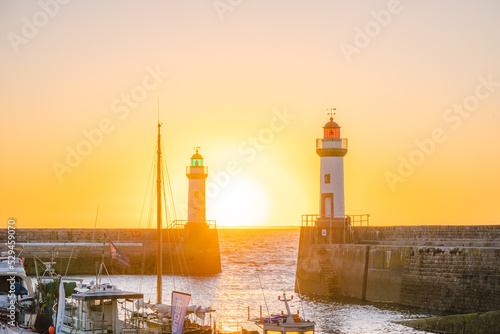 Sunrise over the city of Le Palais in Belle-Ile-en-Mer, and its two famous lighthouses photo