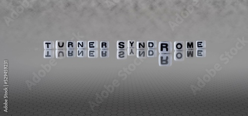 turner syndrome word or concept represented by black and white letter cubes on a grey horizon background stretching to infinity