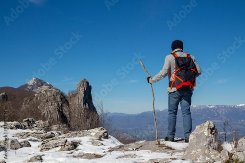 Hiker on the summit of a mountain with snow on the Alburni mountains (SA)