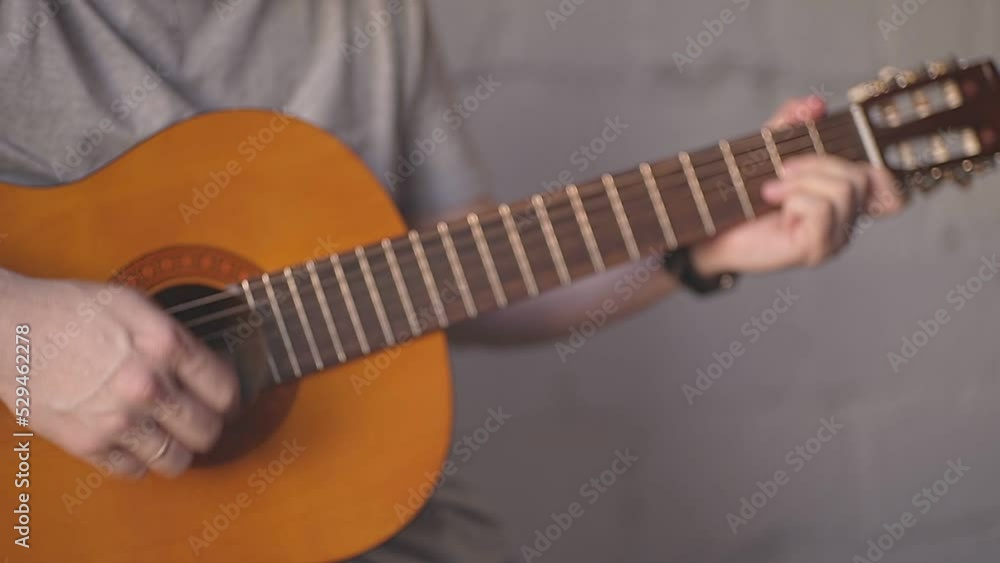 man learning to play acoustic guitar man learning to play acoustic guitar
