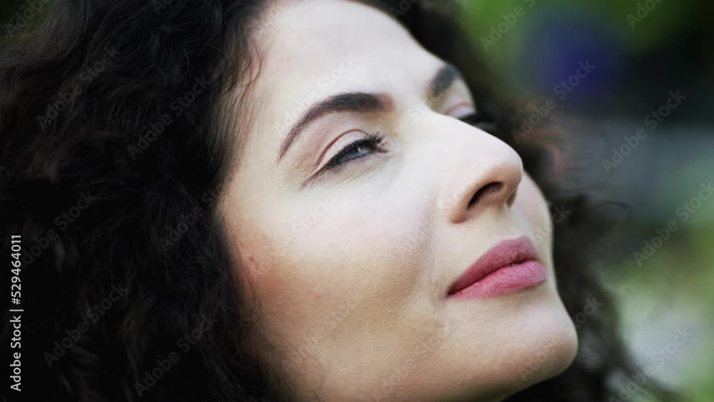 Grateful young woman opening eyes to SKY smiling. Spiritual female person closeup face in contemplation Grateful young woman opening eyes to SKY smiling. Spiritual female person closeup face in contemplation