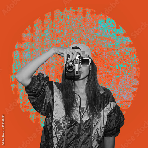 Stylish woman in jacket holding vintage camera isolated on orange background. Old fashioned style. The concept of surrealism, inspiration. Contemporary Arts. Modern art collage. photo