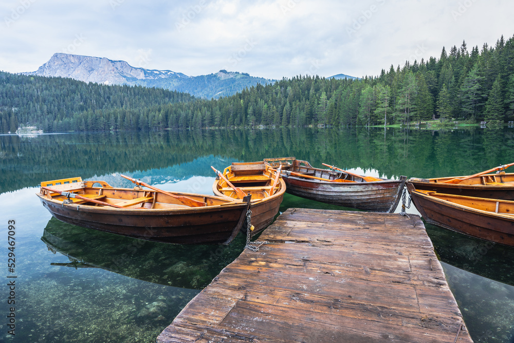 Black lake with boats on mount Durmitor, Montenegro