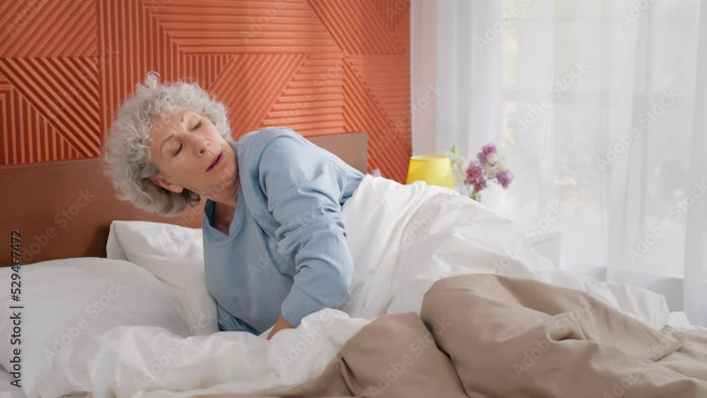 Senior woman wake up from cough feeling sick and resting in bed Senior woman wake up from cough feeling sick and resting in bed