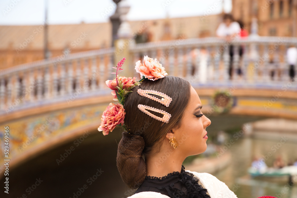 Detail of head with flowers and hairpins of a beautiful teenage