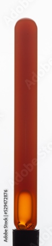 Free Download Yellow viscous liquid sunflower lecithin with bubbles in a transparent test tube on a white background - GFXLoad