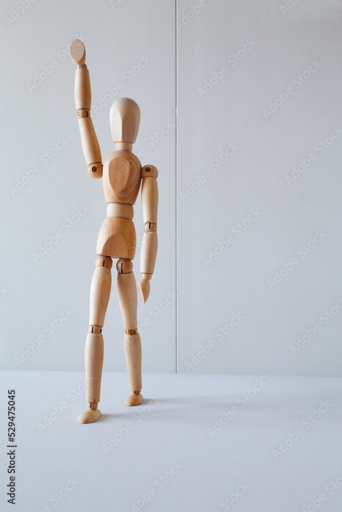 Greeting or leadership concept represented in a wooden doll Greeting or leadership concept represented in a wooden doll