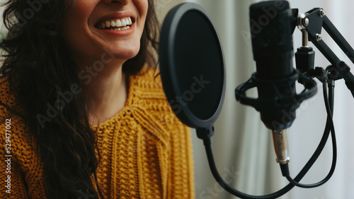 Young woman dubbing voiceover for broadcast stream live show