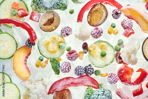 Fototapeta Naklejka Na Ścianę i Meble -  Slices of frozen vegetables on ice. Stocks of food consept. Top view. Background