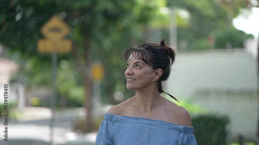 One contemplative middle age woman standing in street in mindfulness. Happy older female person in contemplation. Meditative senior lady One contemplative middle age woman standing in street in mindfulness. Happy older female person in contemplation. Meditative senior lady