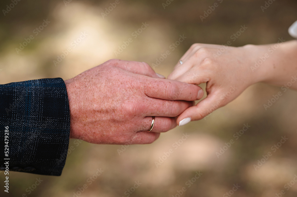 hands of bride and groom with gold rings hold together on the wedding day hands of bride and groom with gold rings hold together on the wedding day