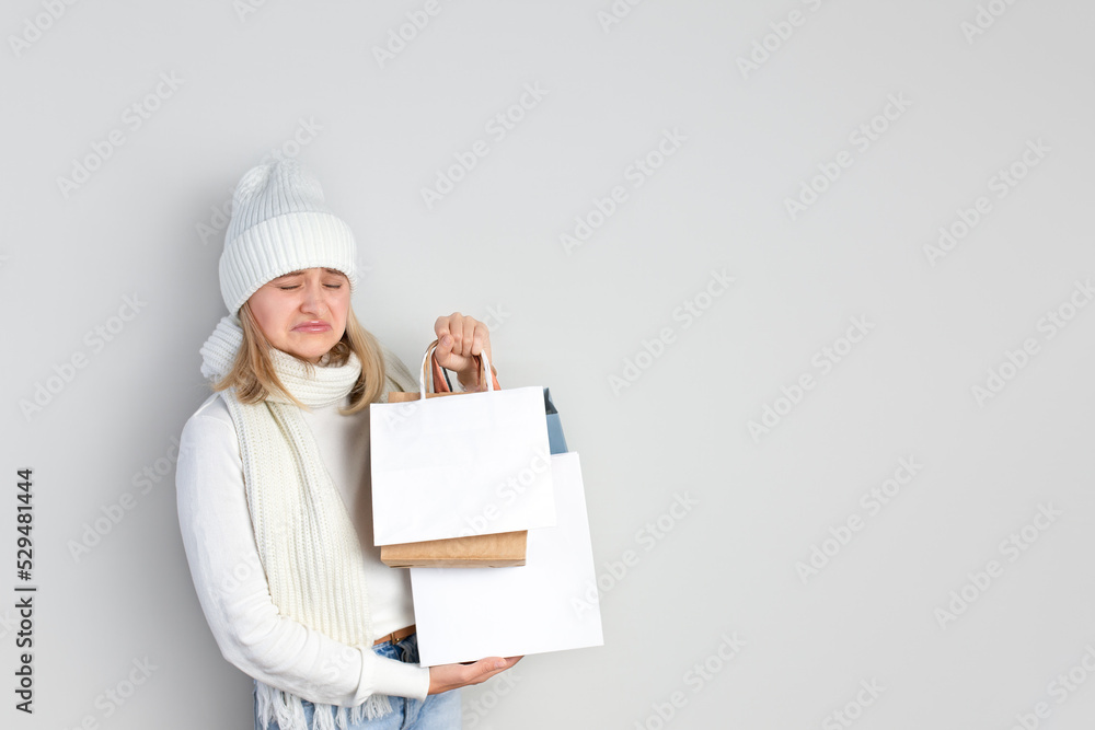 Woman with packages in her hands on a white background. Happy shopping. black Friday. winter shopping. free space for text Woman with packages in her hands on a white background. Happy shopping. black Friday. winter shopping. free space for text