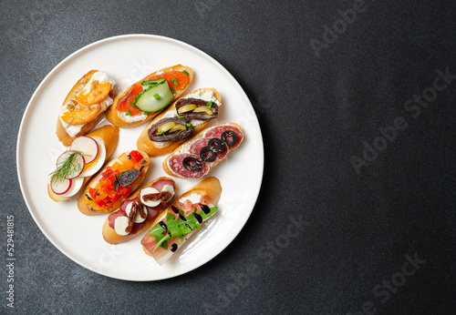 Photography Brushetta, antipasti  or authentic traditional spanish tapas set on white plate