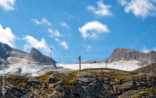 view onto the mountain Kitzsteinhorn, the remains of the glacier Schmiedingerkees and some gondola cableways at summer, Austria