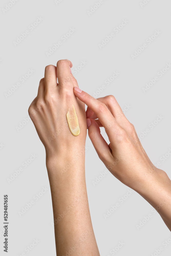 Woman applying lotion to hand. Daily skincare and body care routine. Close up. Woman applying lotion to hand. Daily skincare and body care routine. Close up.