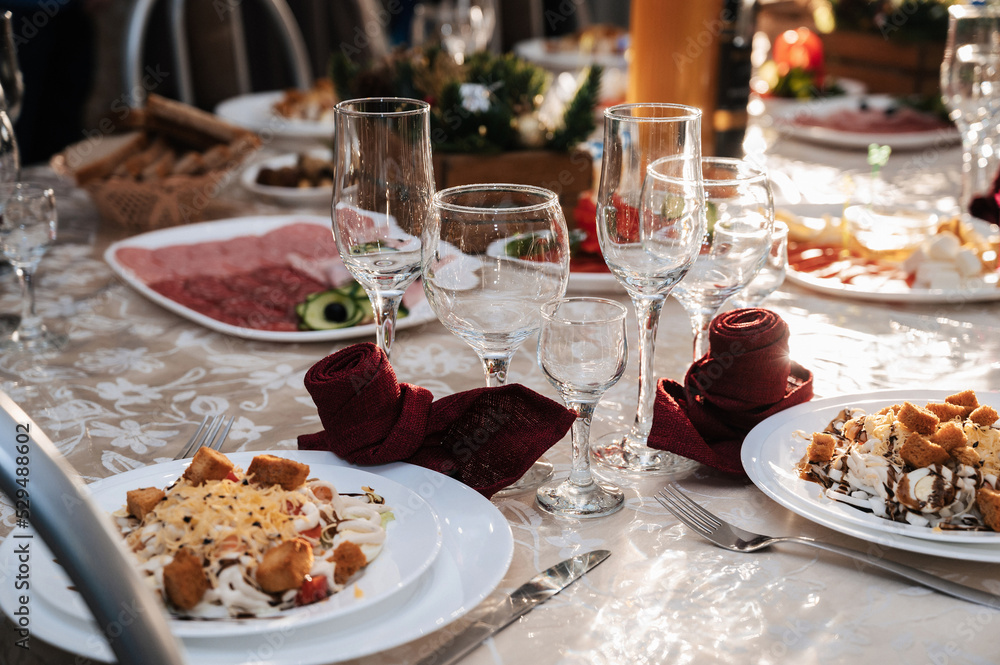 festive table with glasses and food on the table in the restaurant