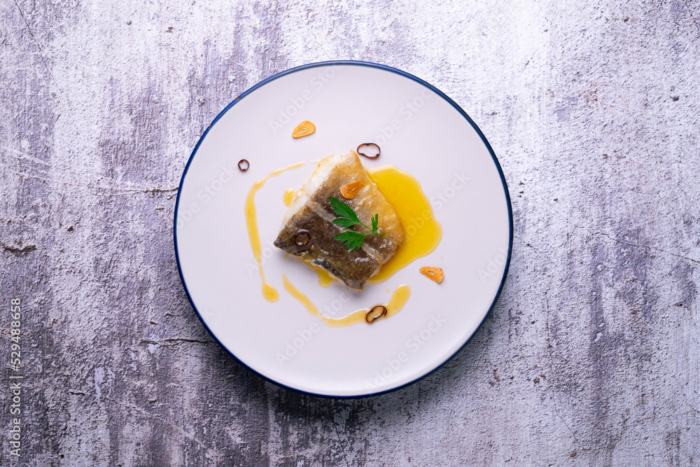 Bacalao al pil pil traditional tapa from the north of Spain. Coconut fish cooked with a delicious sauce made with oil, cod and garlic. Bacalao al pil pil traditional tapa from the north of Spain. Coconut fish cooked with a delicious sauce made with oil, cod and garlic.