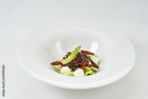 piece of fresh lettuce, sun-dried tomatoes, feto cheese