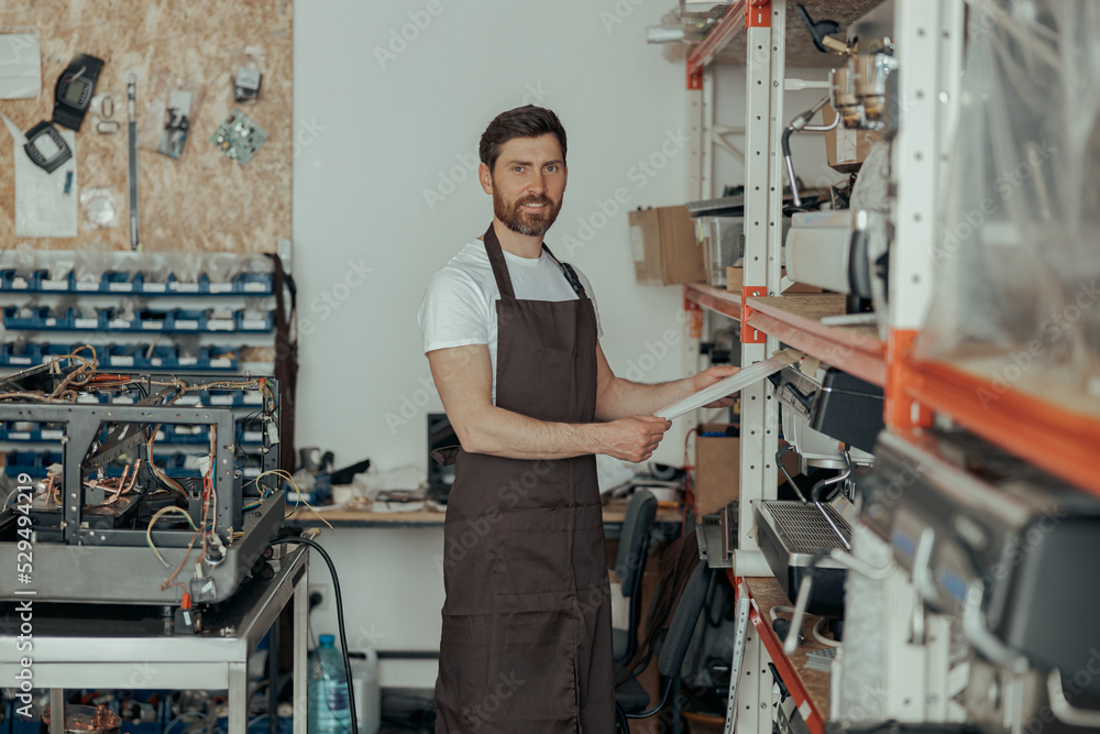 Business owner working on workshop with different coffee machines Business owner working on workshop with different coffee machines