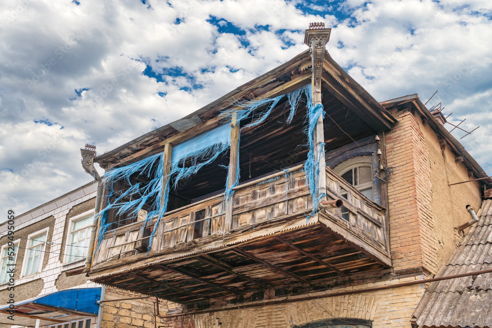Ancient wooden balcony in an old residential building