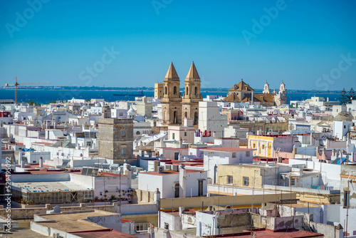 Aerial panoramic view of the old city rooftops and Cathedral de Santa Cruz in the morning from tower Tavira in Cadiz, Andalusia, Spain
