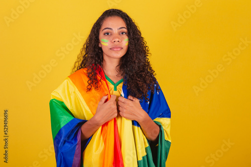 Young black Brazilian woman, soccer fan. with the LGBT and Brazilian flag, Fight against prejudice. seriousness