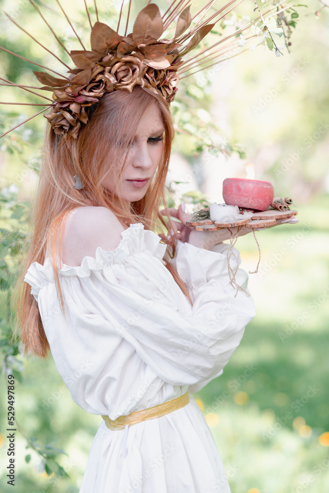 Fototapeta premium Bride of the sun in white in the apple trees 