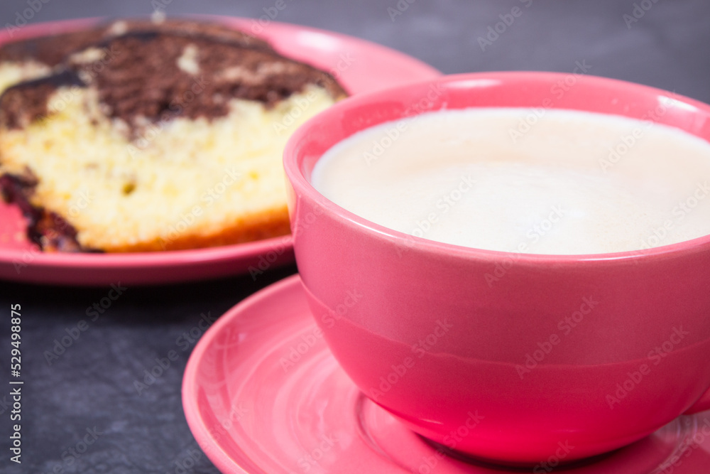 Cup of cappuccino and fresh baked yeast dough with cocoa. Delicious dessert Cup of cappuccino and fresh baked yeast dough with cocoa. Delicious dessert