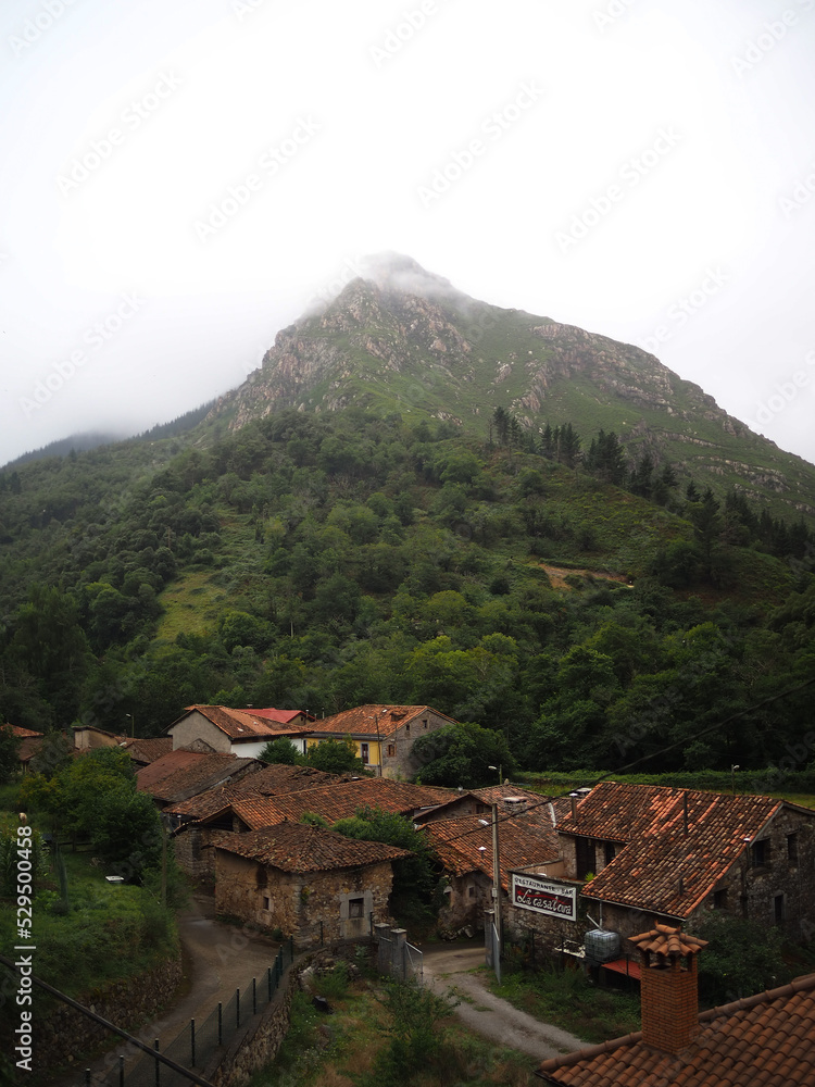 A small abandoned village at the foot of a huge mountain