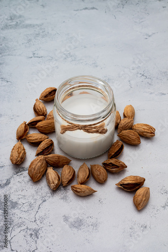 World Vegan Day concept. Nut milk in glass jar with almond. Homemade alternative dairy product. Plant based, lactose free. Tasty and healthy. Selective focus