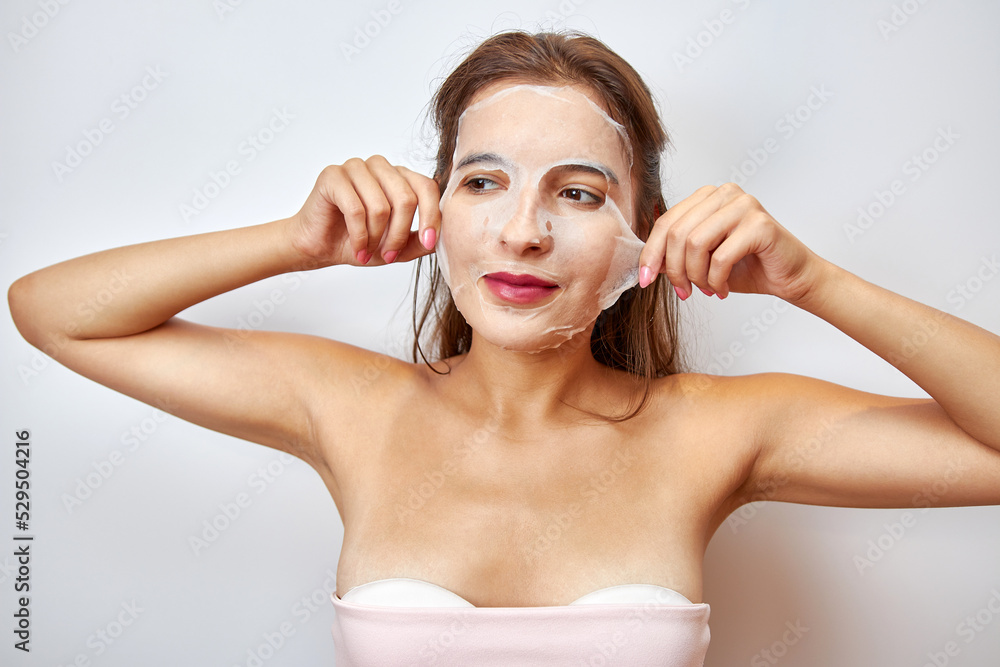 A girl uses a mask for facial care. Beauty concept, skin care cosmetics, facelift. Beauty salon. Removal of wrinkles. A girl uses a mask for facial care. Beauty concept, skin care cosmetics, facelift. Beauty salon. Removal of wrinkles.