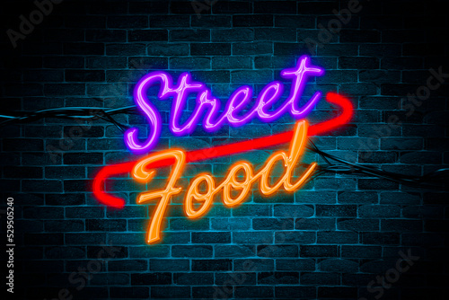 Street Food sign symbol neon banner on brick wall background.